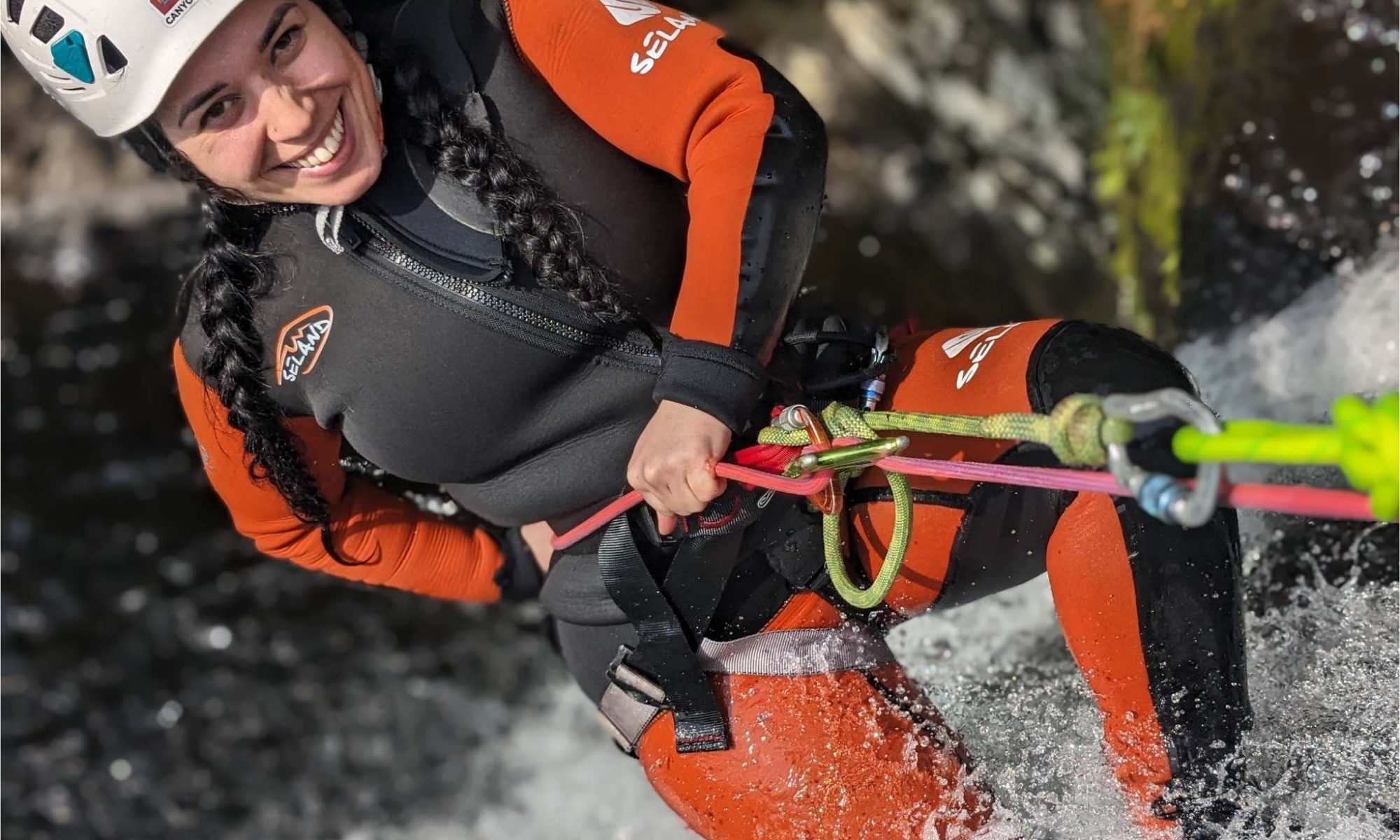 Person abseiling down a waterfall during a Galloway Canyoning adventure in Scotland