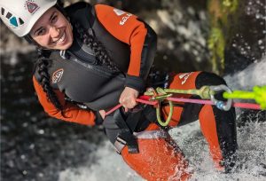 Person abseiling down a waterfall during a Galloway Canyoning adventure in Scotland