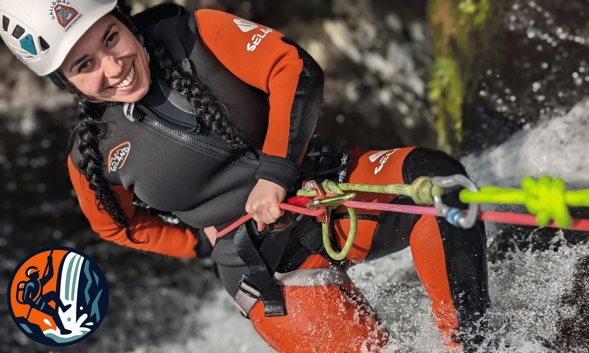 Adventurer canyoning across a scenic Scottish waterfall in Galloway