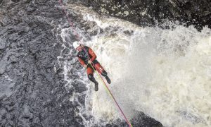 Canyoning in Scotland - zipline ride over a rushing waterfall